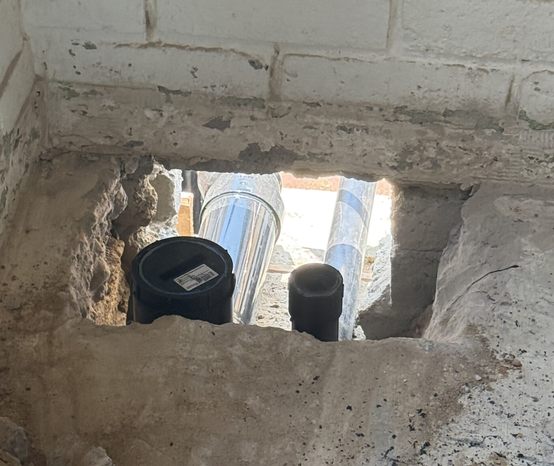 Technician installing a water filtration system in an Oceanside, CA home