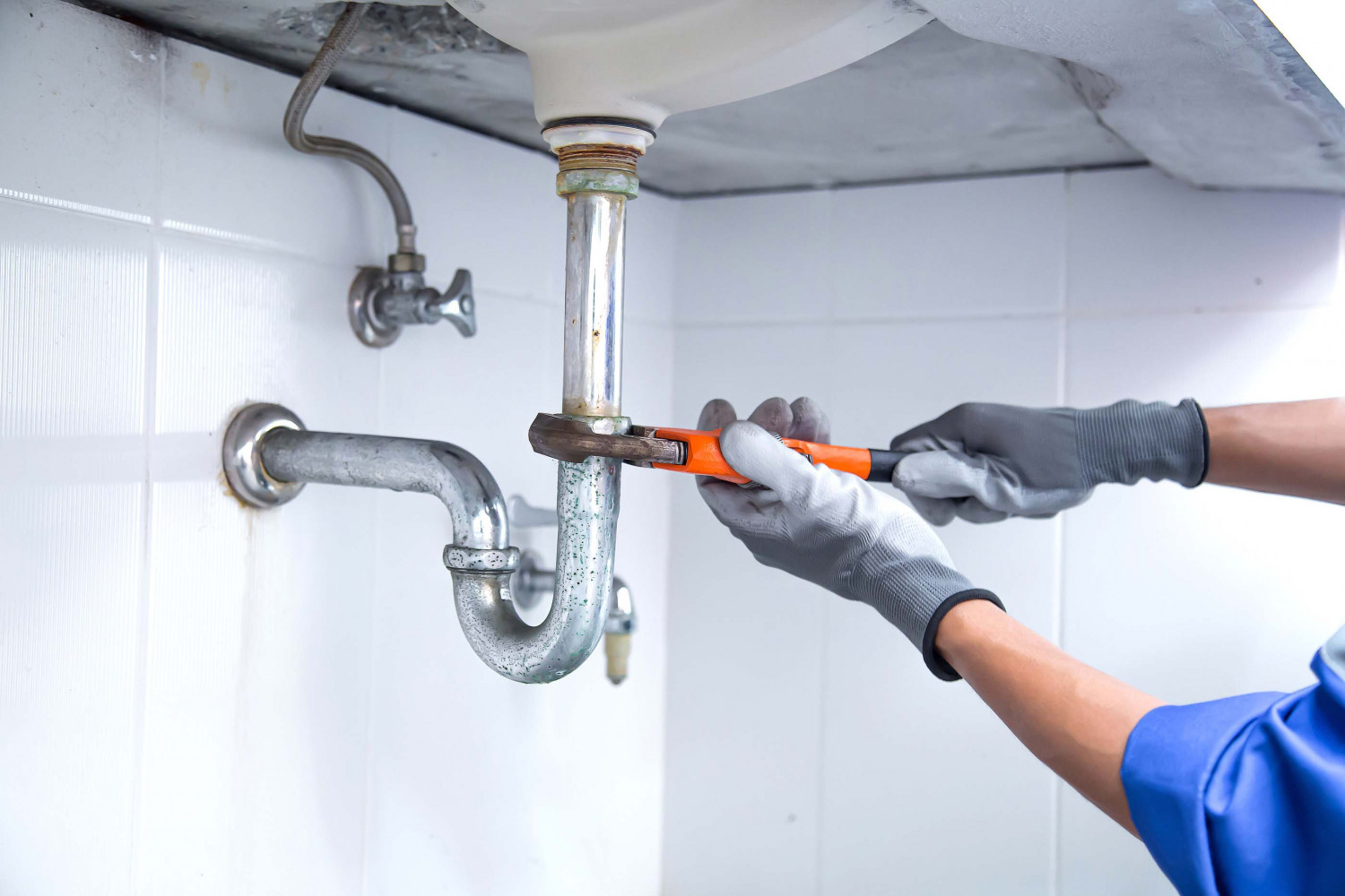 Plumber removing old galvanized pipes during a repipe in Oceanside, CA