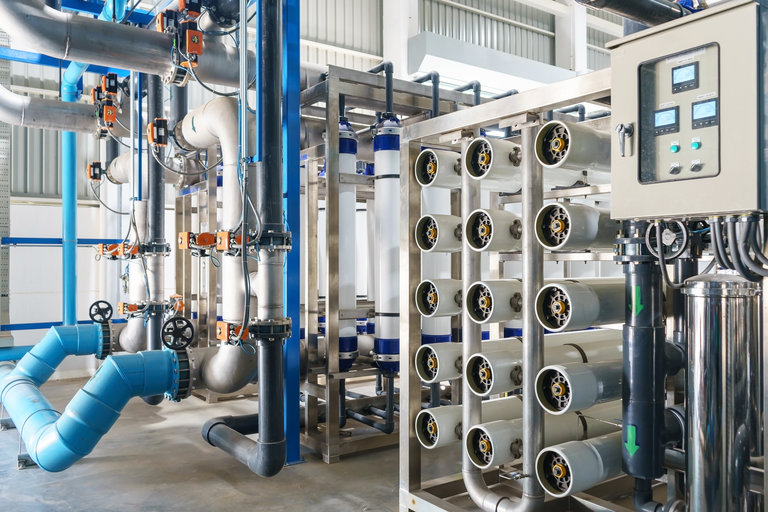 Technician installing a water filtration system in an Oceanside, CA home