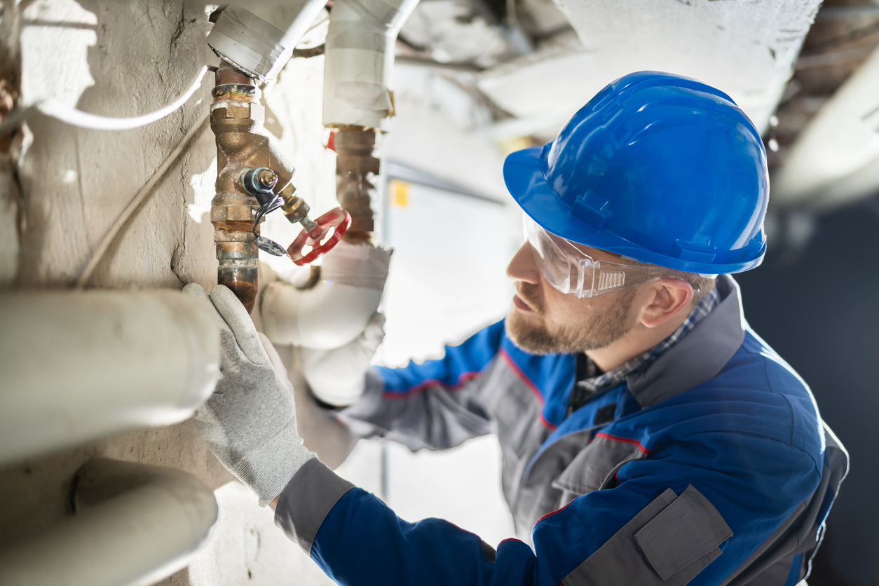 Plumber removing old galvanized pipes during a repipe in Oceanside, CA