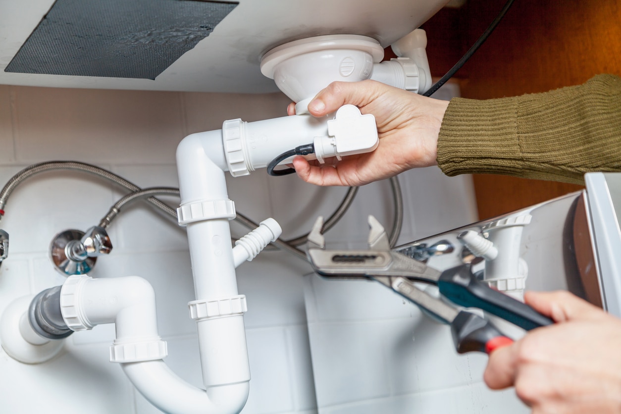 Plumber removing old galvanized pipes during a repipe in Oceanside, CA
