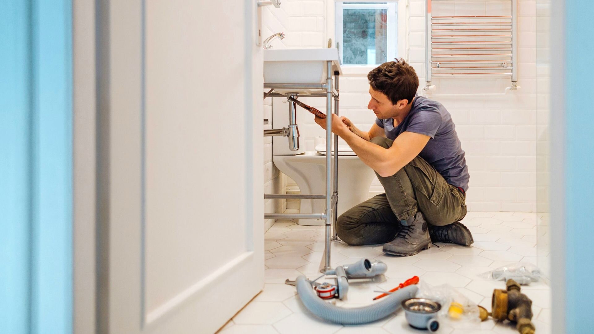 Plumber removing old galvanized pipes during a repipe in Oceanside, CA