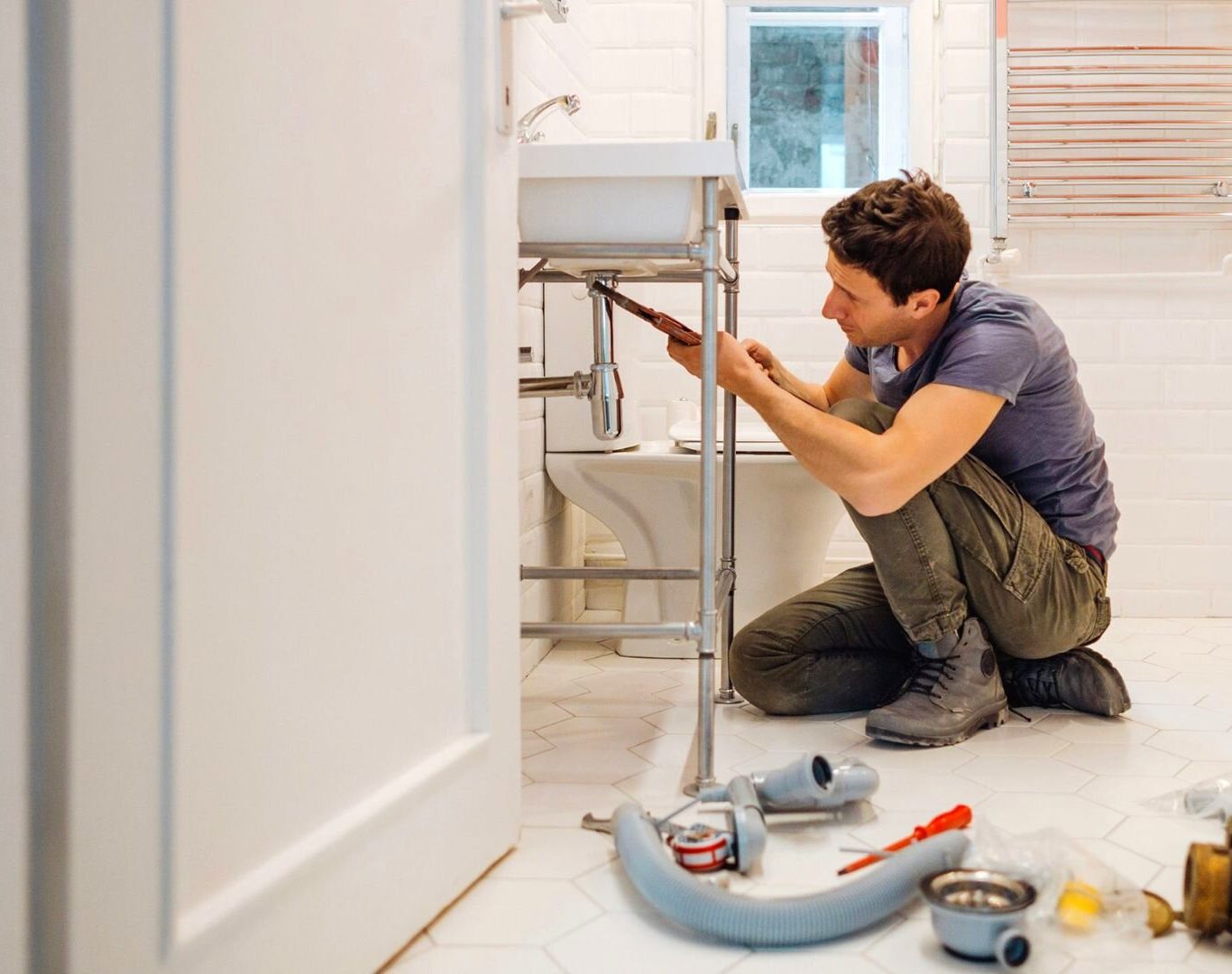Plumber removing old galvanized pipes during a repipe in Oceanside, CA